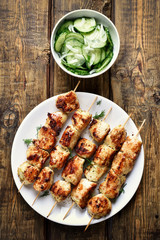 Chicken kebabs and cucumber salad