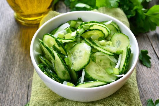 Cucumber salad in white bowl