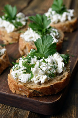 Fototapeta na wymiar Bread with curd cheese and herbs