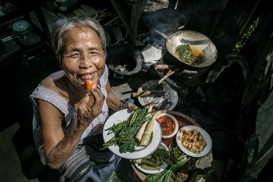 Senior Woman Chef Cooks In The Kitchen