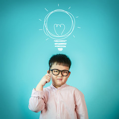 Concept, idea of happy child boy with bulb at blackboard, new fa