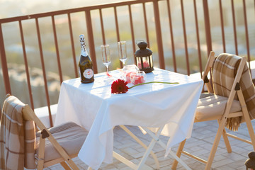 Romantic dinner on the roof at sunset