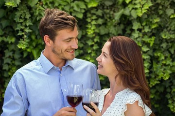 Romanic couple looking at eachother while holding wineglasses