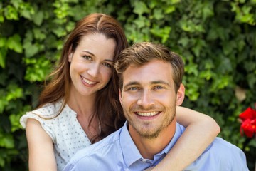 Fototapeta premium Portrait of happy couple at front yard