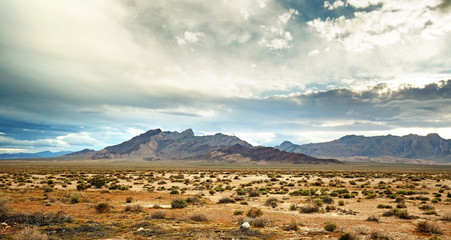 panoramic view of the mojave desert under a cloudy sky - 107514363