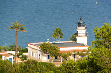 Fototapeta na wymiar View of lighthouse from the beach of Calella near Barcelona, Spain.