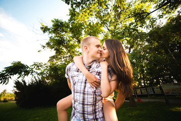 Fototapeta premium young teen couple in love having fun and enjoying the beautiful nature in park