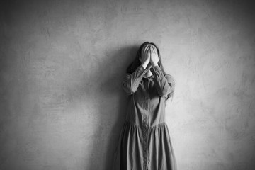 Sad woman covering her face