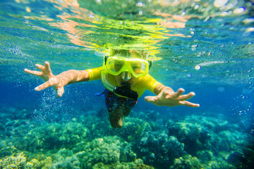 Boy dives in a tropical sea