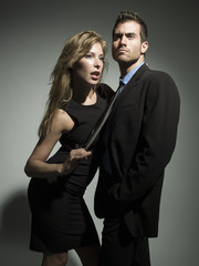 elegant fashionable couple in black suit and dress