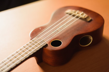 Fototapeta na wymiar Vintage ukulele on wooden table