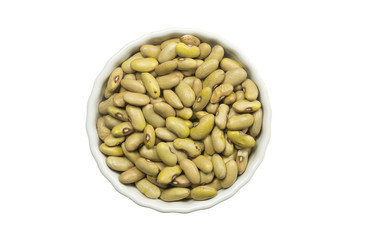 Yellow beans in a ceramic pot on white background