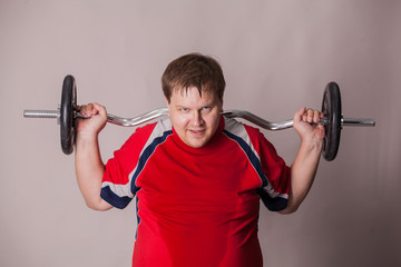 fat man is involved with dumbbells