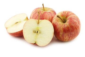 fresh sweet small apples and a cut one on a white background