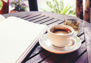 Coffee cup on wooden table - Vintage effect style pictures, over light [blur and select focus background] 