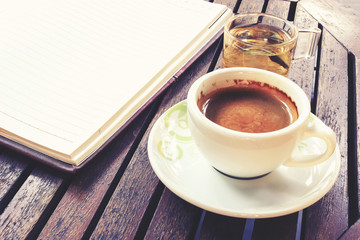 Coffee cup on wooden table - Vintage effect style pictures, over light [blur and select focus background] 