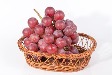 grapes in a basket isolated on white background