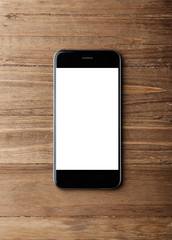 Photo of modern smartphone on wood background. Blank screen ready for business information. Vertical