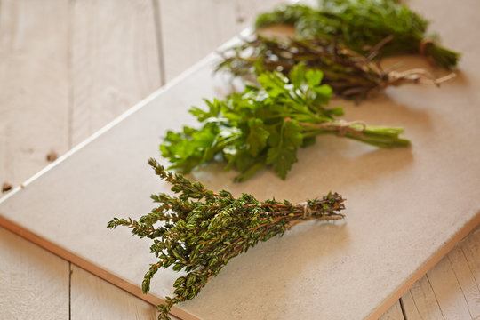 Assorted herbs, parsley, rosemary, dill,  and fresh thyme on white background