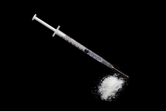 Drug Syringe And Heroin Powder With Danger Concept.