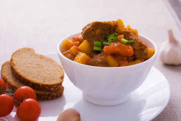 Homemade goulash with slices of bread
