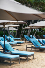 few sun loungers and parasols on the beach