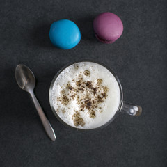 Cup of cappuccino and macaroons
