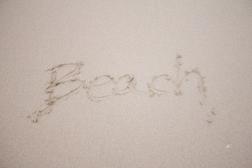 beach hand writing on the sand