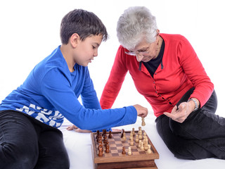 Grandmother with Grandson / Grandmother with her grandson playing chess. White background.