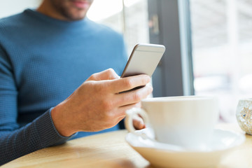 close up of man with smartphones at cafe