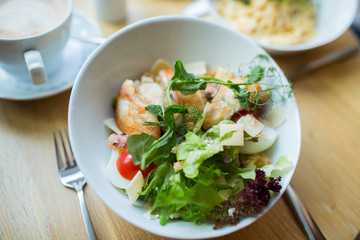 close up of caesar salad on plate at restaurant