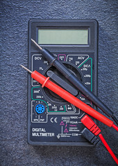 Digital multimeter electric tester on black background electrici
