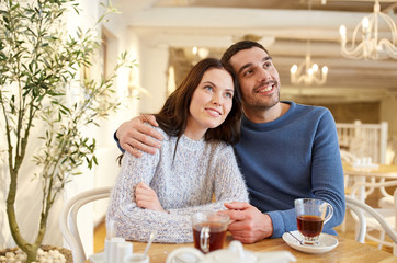 happy couple drinking tea at restaurant