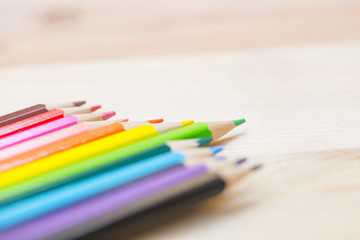 Fototapeta premium color pencil with sharpener on wood background, colorful kids school artist concept.