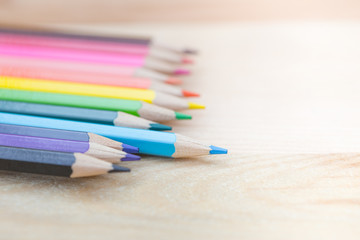 Fototapeta premium color pencil on wood background, colorful kids school artist concept.
