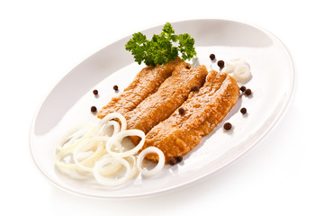 Marinated fried herring fillets on white background 