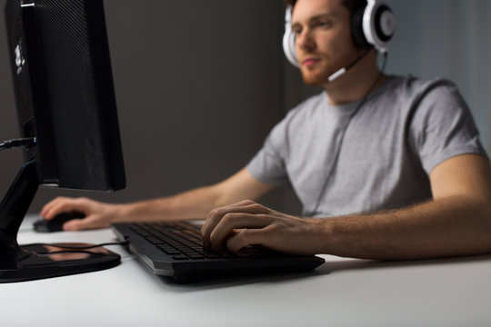 close up of man playing computer video game