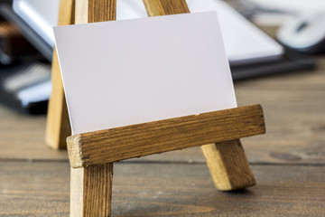 small wooden easel with paper