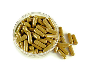 Herbal drugs capsules isolated on white.