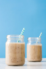 Banana smoothie on blue background
