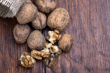 walnuts on a wooden table with a bag