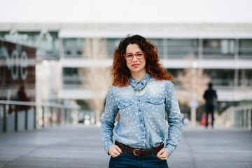 Fototapeta premium Portrait of young woman in eyeglasses looking at camera