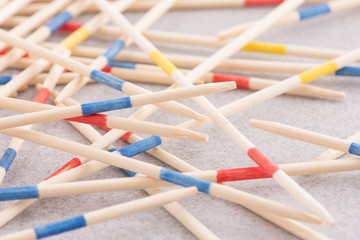 Fototapeta premium Mikado game wooden sticks on table. Concept of fun game with strategy, a real mess or chaos.