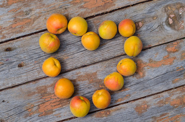 The apricot heart on the wooden background for Saint Valentines Day