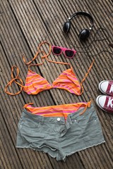 Beachwear Laydown including bikini, cut down shorts, pumps, sunglasses, headphones 