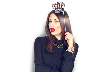 Winking sexy model girl holding funny paper crown on stick