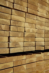 Wood lumber boards stacked ready for building industry