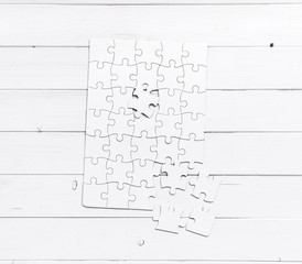 white unfinished puzzle on white table