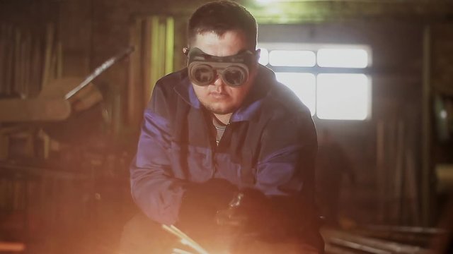 worker cuts metal with gas