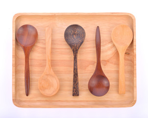 Wooden plate with  spoon isolated on white background